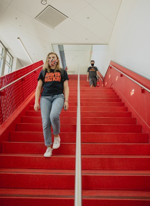 Two students descending staircase in the LinC building