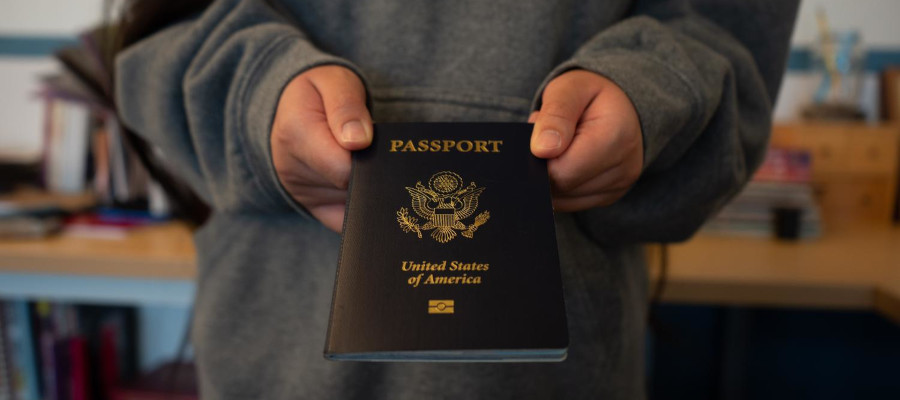 Photo illustration depicts a passport being handed over by someone wearing an Oregon State University hoodie on May 29. Currently the program “Get a DAM Passport!” is open to 50 first-year and transfer students in the College of Agriculture or the College