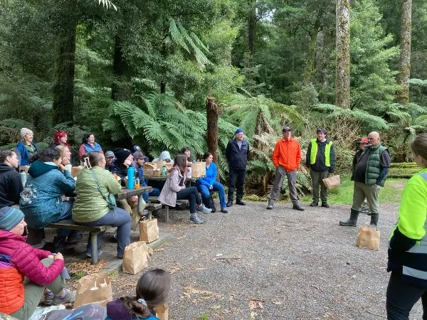 Group of students listen to Chaz, representative of the Maori people.