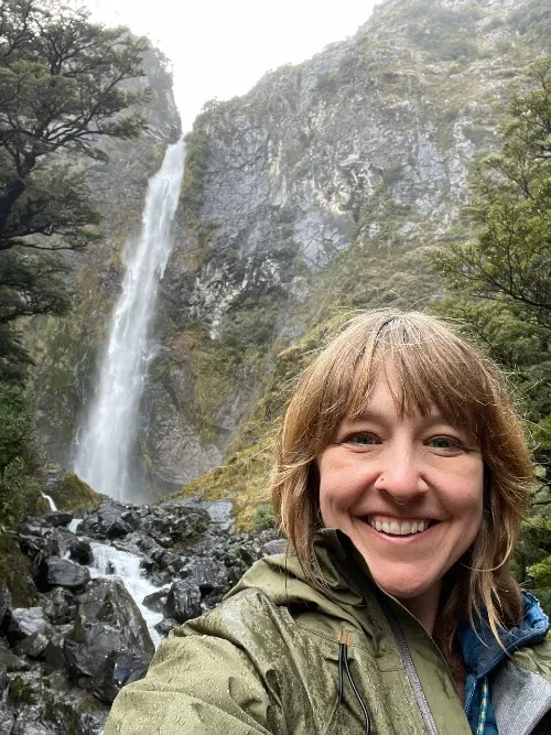Stephanie McSpadden-Rowlan in front of waterfall