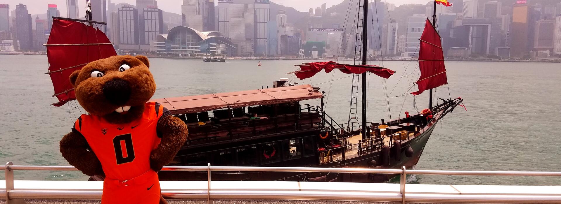 Benny Beaver standing in front of a ship in Shanghai, China